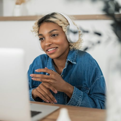 african american woman wear headphones video calling on laptop.teacher ot tutor holding online african american woman wear headphones video calling on laptop.teacher ot tutor holding online