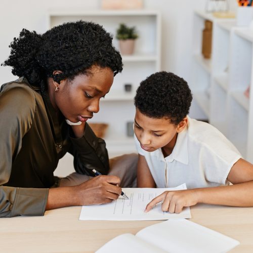 Black Female Tutor Helping Student at Home Experienced tutors in Pretoria helping students excel in their studies